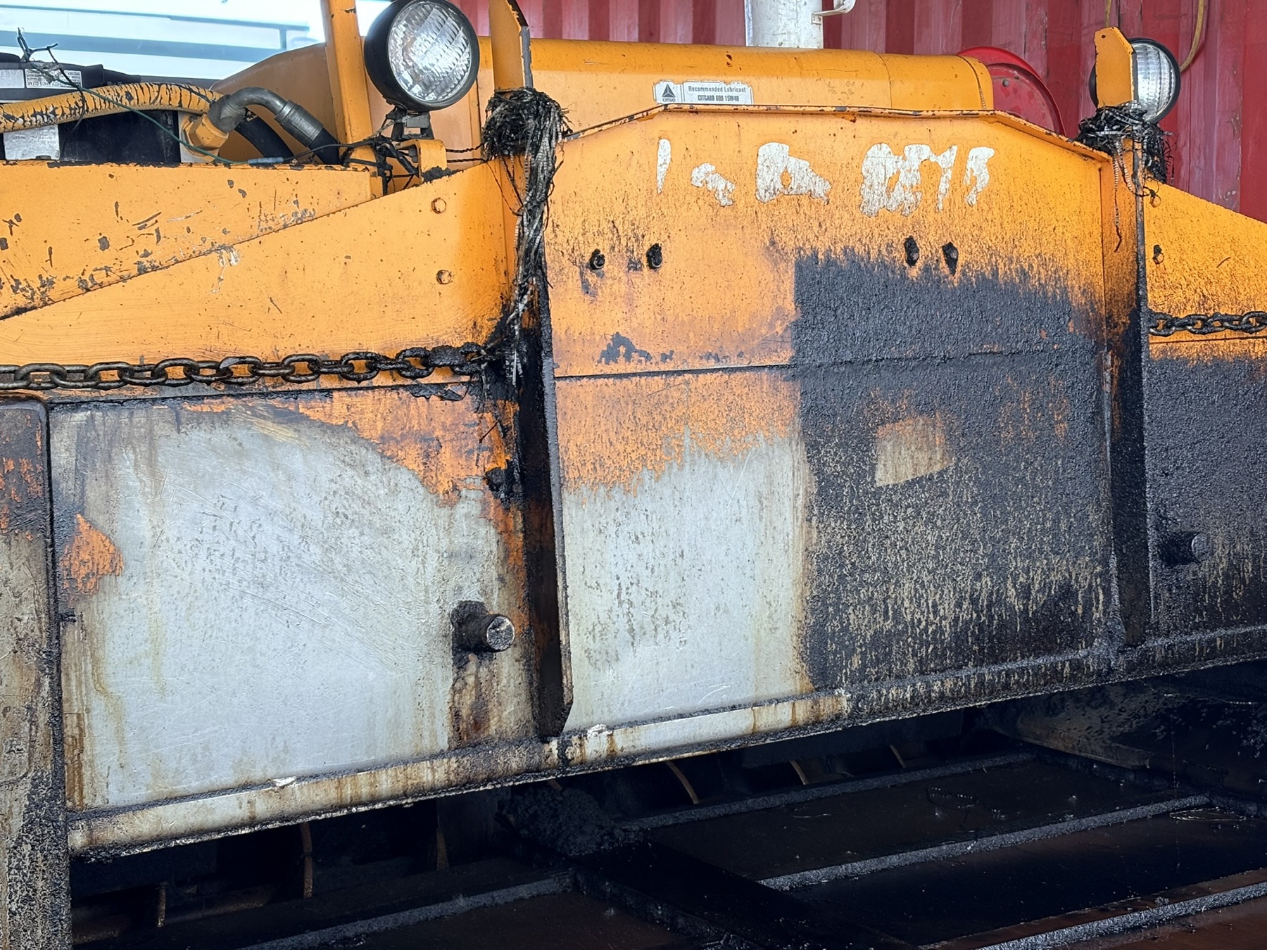Field comparison on an older paver: cleaned area on the left and asphalt buildup on the right